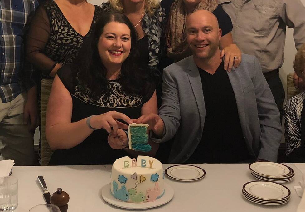 BABY BLUE: Cr Jaimie Abbott and her partner of 13 years, Matt Bailey. Cr Abbott had her obstetrician contact the cake maker by way of announcement. This photo taken on the night their family learned they were pregnant. 