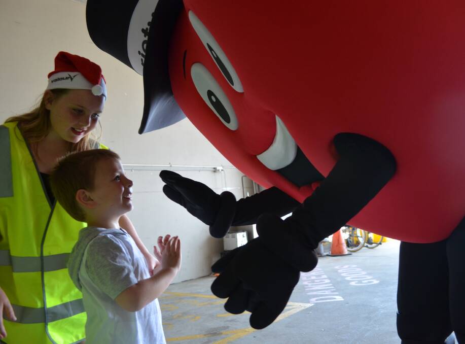 THRILLED: Levi Gardner, 3, of Jesmond, with Heartly, the Variety mascot, who was another unexpected visitor at Newcastle Airport on Monday.