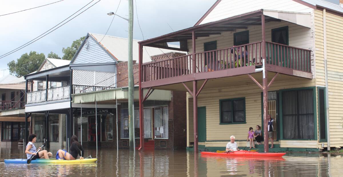 HIGH WATER: King Street, Raymond Terrace, April 23, 2015. When the wind and rain subsided people assessed the damage. Picture: Ellie-Marie Watts