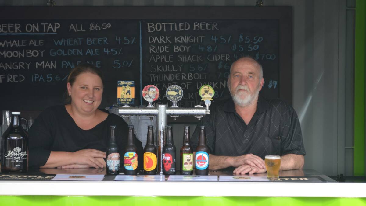 HOPPING TO IT: Murray's staff Jane Clack and Brian Swift have wasted no time welcoming people back to Bobs Farm after fire ripped through the cellar door. Picture: Sam Norris