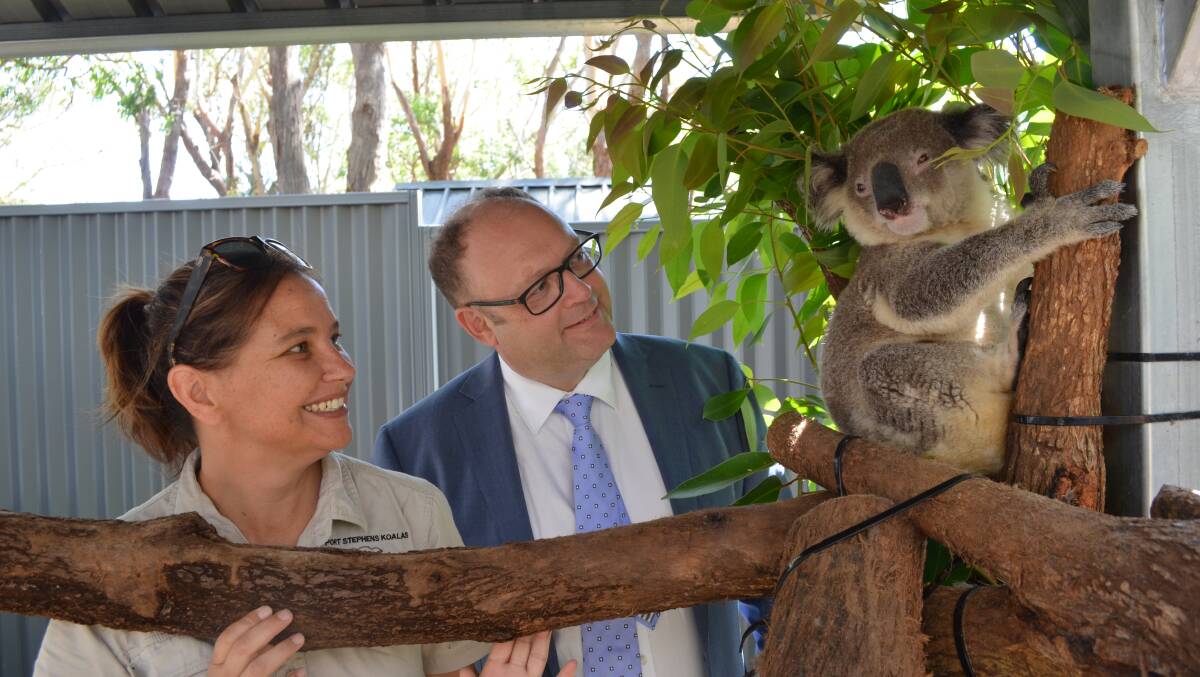 HELPING HAND: Port Stephens Koalas hospital co-ordinator Kate King and Hunter Water managing director Jim Bentley with one of the patients at the rehabilitation facility. Picture: Sam Norris