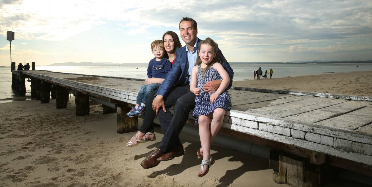 TREADING THE BOARDS: Mayor Elect of Port Stephens, Ryan Palmer with his wife Jess, children Knox 2 and Bella 6. Photographed at Little Beach, Nelson Bay. Picture: Marina Neil