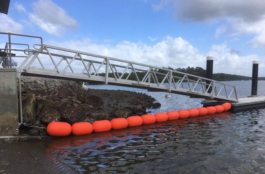 BUOY LINE: The Port Stephens Council project team put their heads together to work out how to stop boats drifting under the gantry. Picture: Port Stephens Council