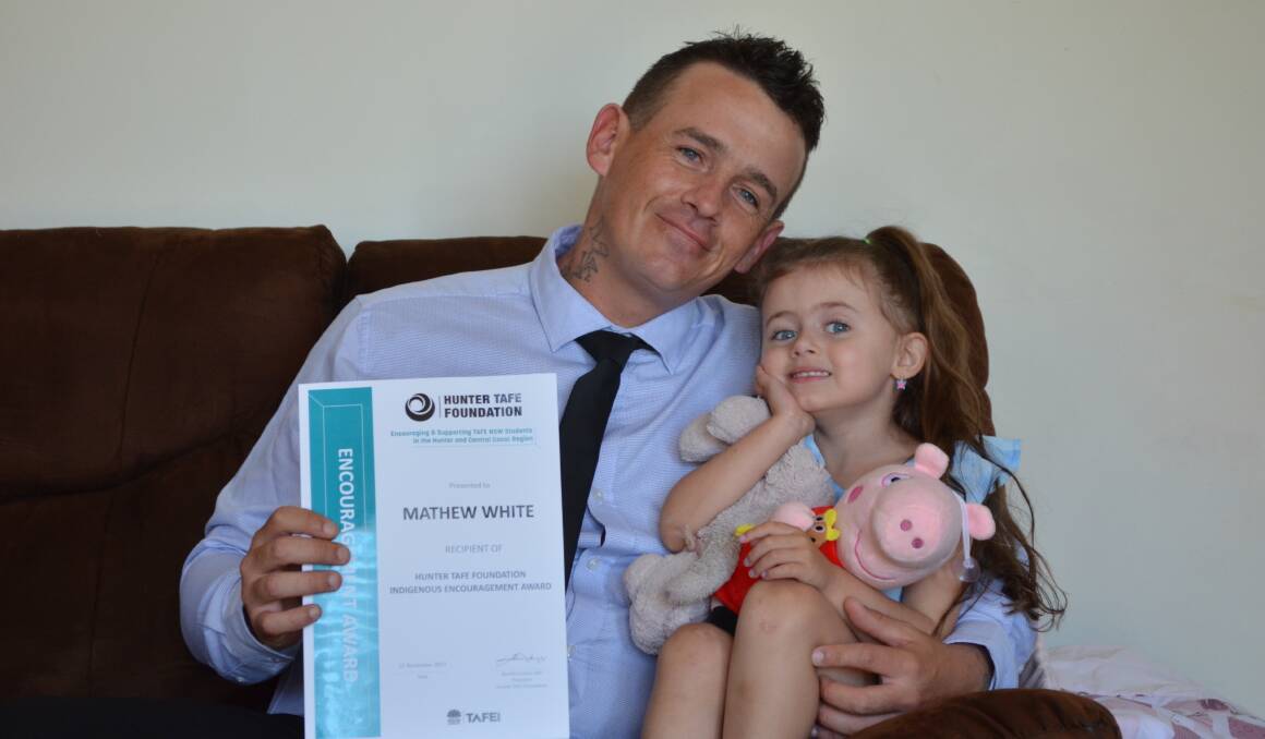 PROUD: Matthew White, 32, with his daughter Evelyn, 3, in their Port Stephens home, after he received the NSW TAFE Indigenous Encouragement Award. Picture: Sam Norris