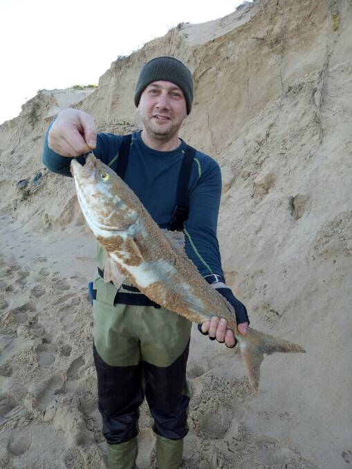 WHAT A CRACKER: Sydney visitor Boris Gembik with a salmon caught on One Mile Beach.