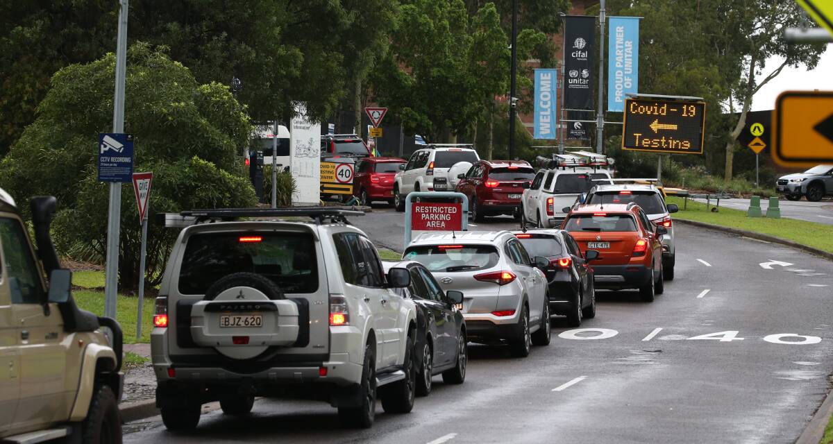 BUSY: Cars queue up to enter the University of Newcastle testing station on Sunday. Picture: Marina Neil 