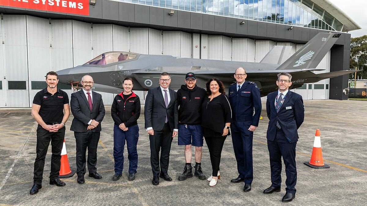 Minister for Defence Industry Pat Conroy with personnel from BAE Systems, Australia at RAAF Base Williamtown.