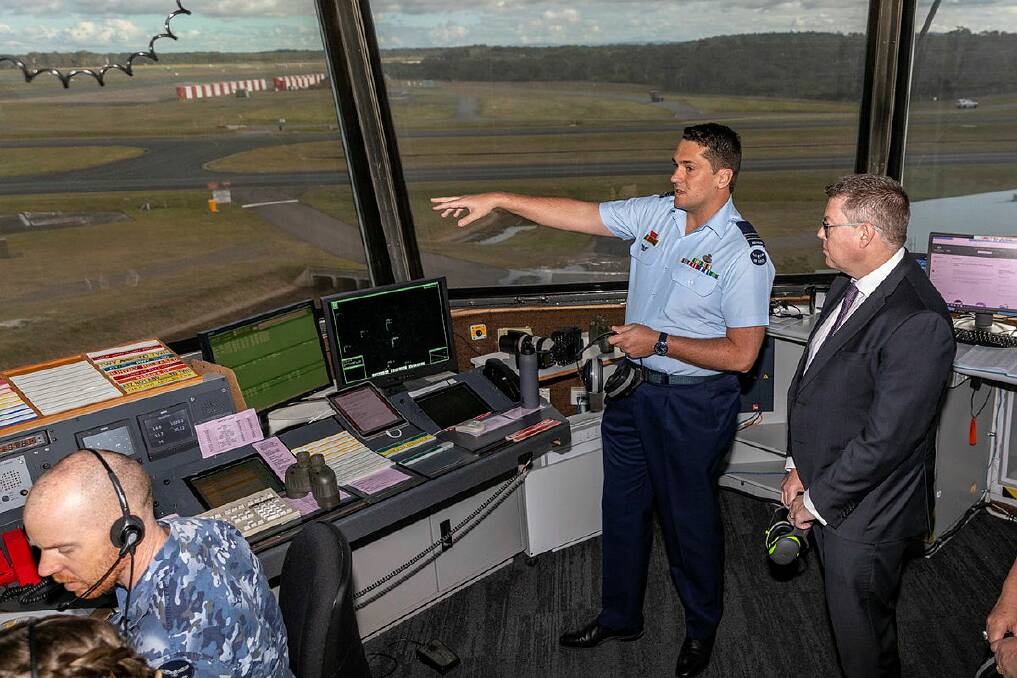 Flight Commander No. 453 Squadron, Williamtown Flight, Squadron Leader Colin Haywood (r) shows Minister for Defence Industry Pat Conroy the view of RAAF Base Williamtown from the air traffic control tower during a recent visit.