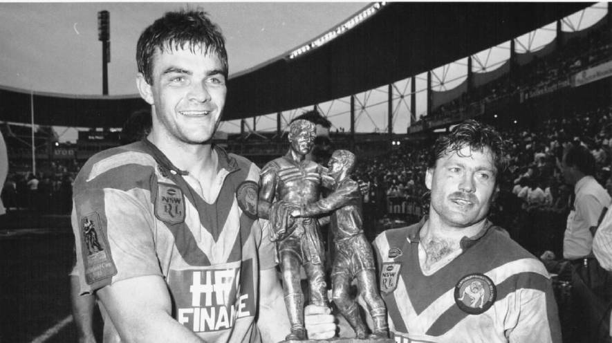 GREATS: Former bulldogs players Paul Dun and Terry Lamb lift the premiership trophy in 1988.