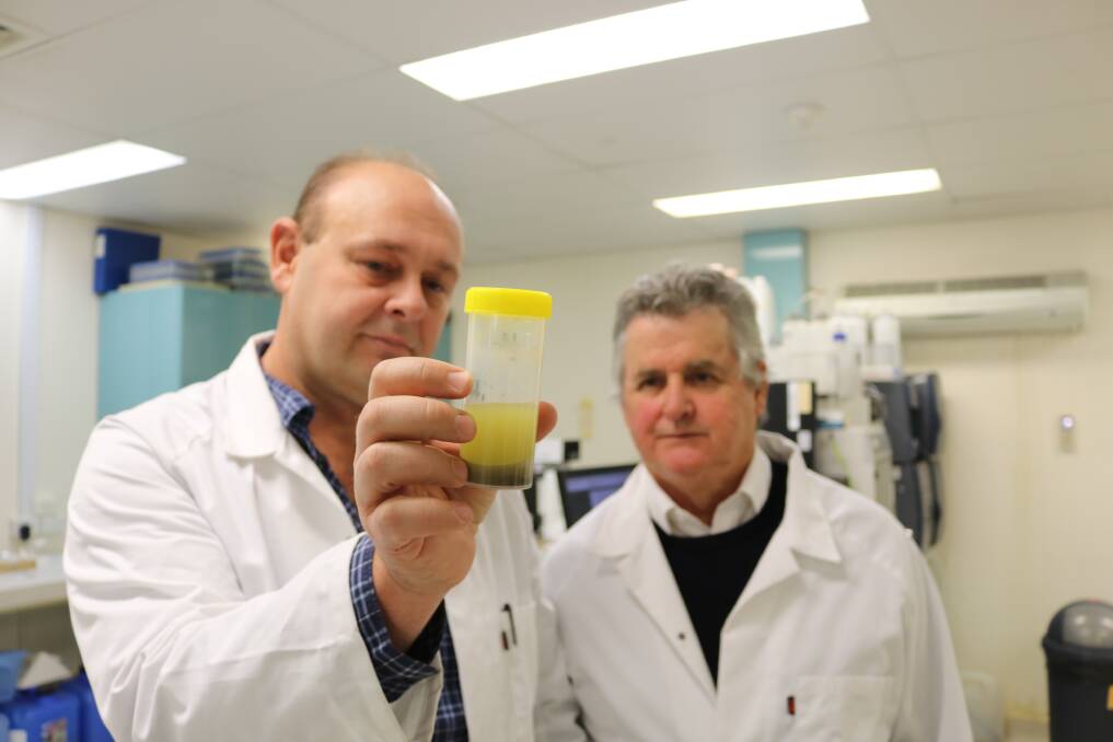 SEARCH: Dr Brett Turner (left) and Professor Scott Sloan, who passed away unexpectedly just weeks after this photo was taken, undergoing research into the treatment of PFAS contamination. Picture: Supplied