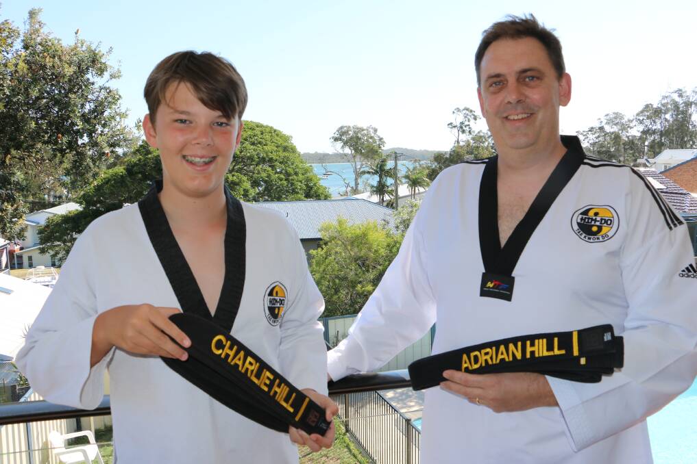 BLACK BELTS: Father and son duo Adrian and Charlie Hill with their black belts at their Corlette home.