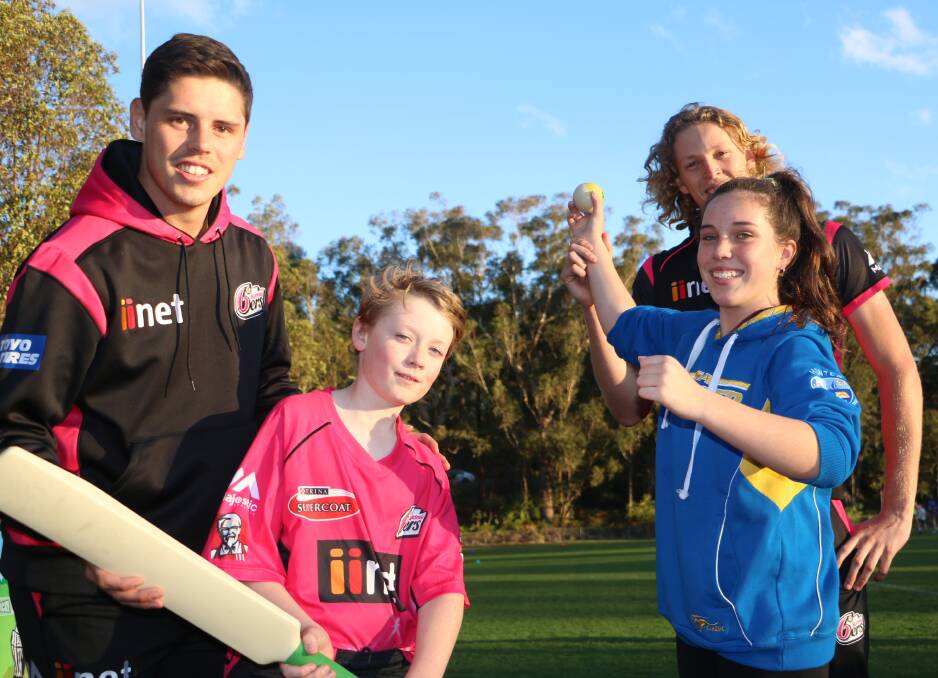HIT FOR SIX: Sydney Sixers' Ben Dwarshius and Jack Edwards (back) with Flynn Weber, 10, and Lillee Banks, 12, at the come and try event at in Nelson Bay on Monday. Pictures: Charlie Elias