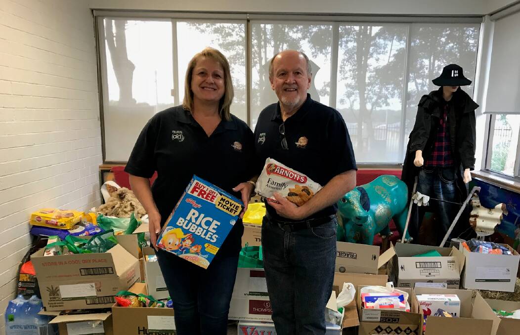 GOODIES: Co-founder of Rural Aid Tracy Alder and Counsellor Phil Hough prepare to take food items donated by Irrawang High students to Cumnock.