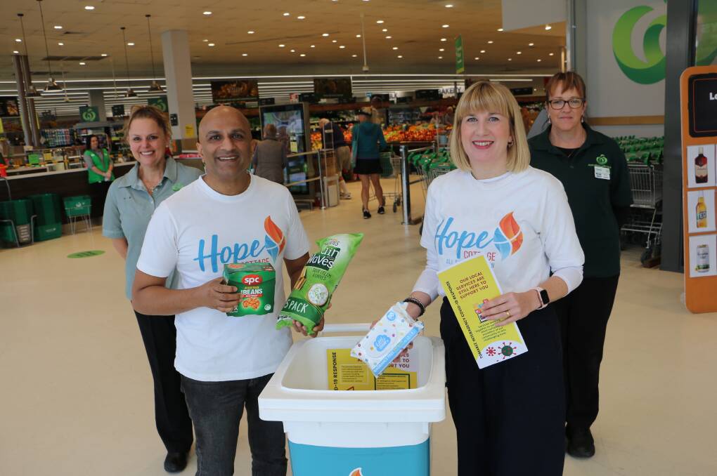 DONATION BIN: Hope Cottage's Kesh and Catherine Govan with items for the Donation food bin at Nelson Bay Woolworths with staff Silvia Karaberis and Cherrie Haddrow.