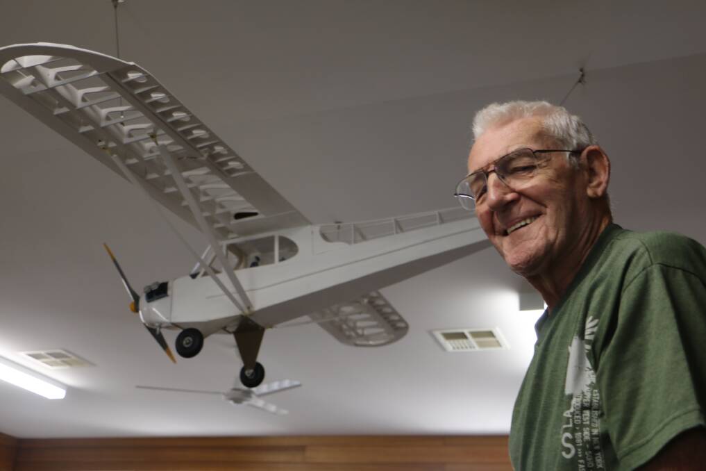 FLYING HIGH: Wally Townsend with his model Piper J-3 Cub proudly displayed in the Harbourside Haven recreation hall at Shoal Bay.