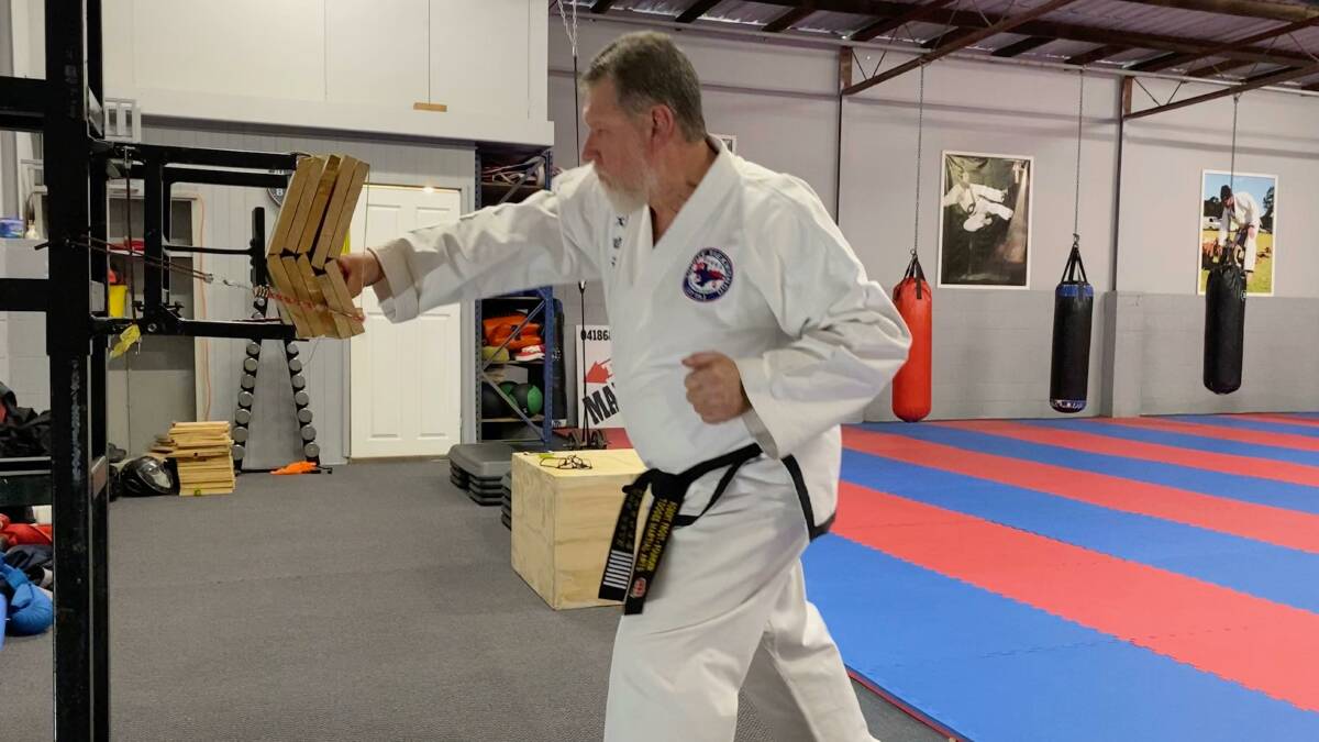 GRAND MASTER: Robert Frost in action at the Raymond Terrace hall where he runs his Toogee martial arts classes. Picture: Supplied
