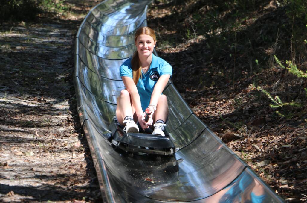 ALL DOWNHILL: Toboggan Hill Park staff member Sienna Breen tests the toboggan run in preparation for an expected bumper school holiday crowd.