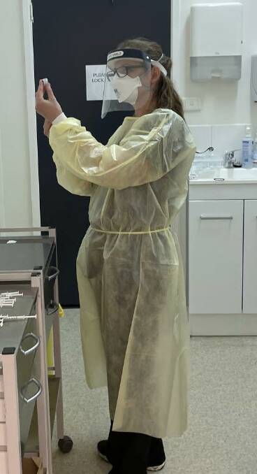 READY FOR USE: A Nelson Plaza Clinic team member in full PPE prepares to administer a vaccine dose. Picture: Supplied