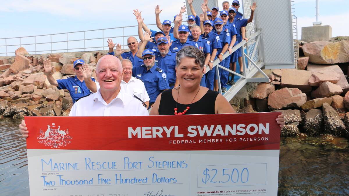 LINK-UP: MP Meryl Swanson presents Marine Rescue Port Stephens unit commander Colin Foote with a cheque to the delight of volunteer crew members at Nelson Bay.