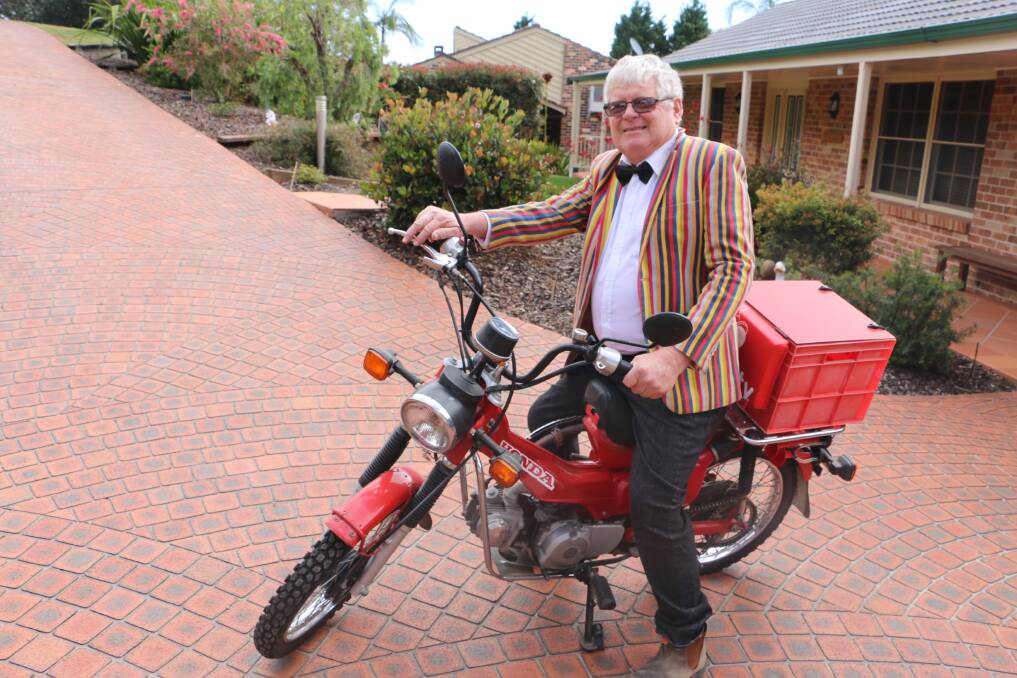 COLOURFUL: Nelson Bay's Warwick Mathieson in bow tie and jacket on his 110cc Honda postie bike.