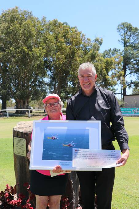 PRESENTATION: Deb Cordner with David Cromarty from the Westpac Rescue Helicopter Service and the framed picture.