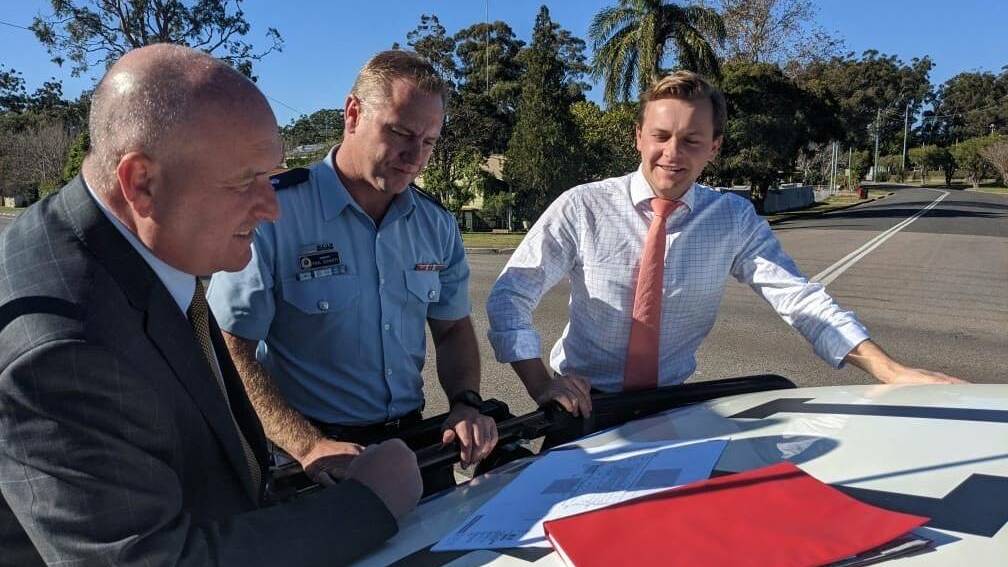 VISIT: Police minister David Elliott, Superintendent Chad Gillies and Taylor Martin inspecting plans for the new Tilligerry police station in June 2020.