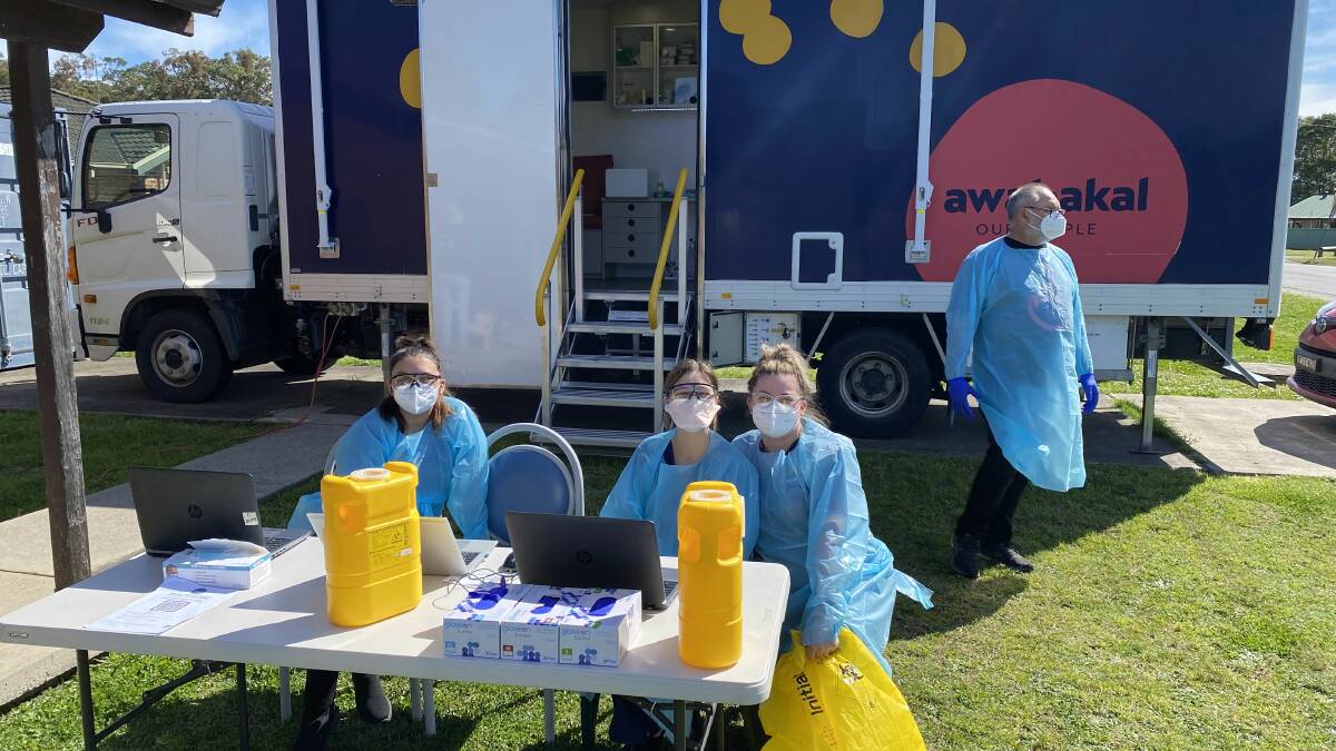 ON HAND: Medical staff prepare to vaccinate the Karuah Aboriginal community.