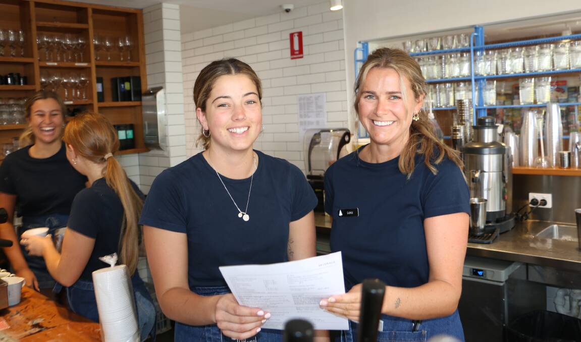HAPPY STAFF: Molly Compton (left) and Lara Hearn during a busy Monday morning shift at The Little Nel cafe in Nelson Bay.