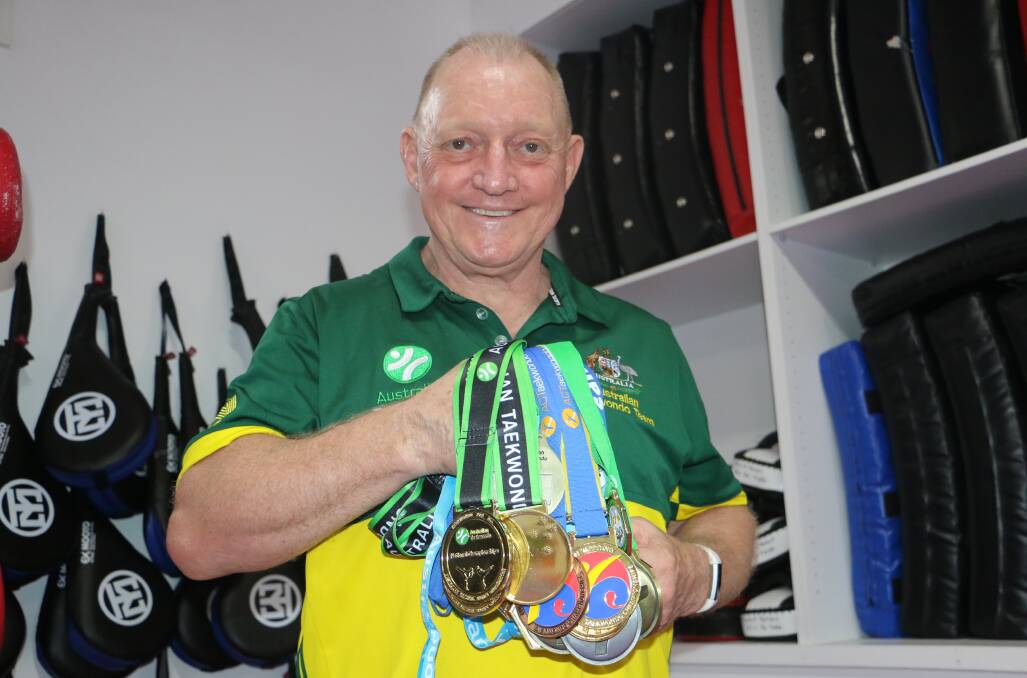 RECOVERED: Taekwondo instructor Ronald Bergan, from Salamander Bay, with the bag of medals he has collected since returning from knee surgeries.