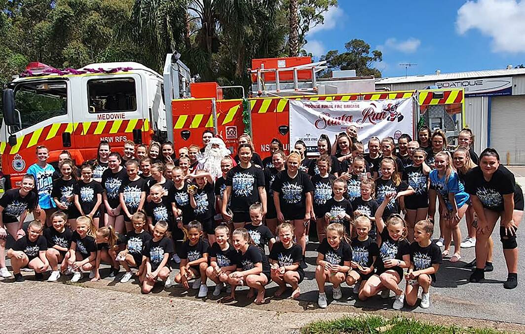 POPULAR: Santa proved to be very popular for kids during the Medowie RFS Christmas run on Saturday. Picture: Supplied
