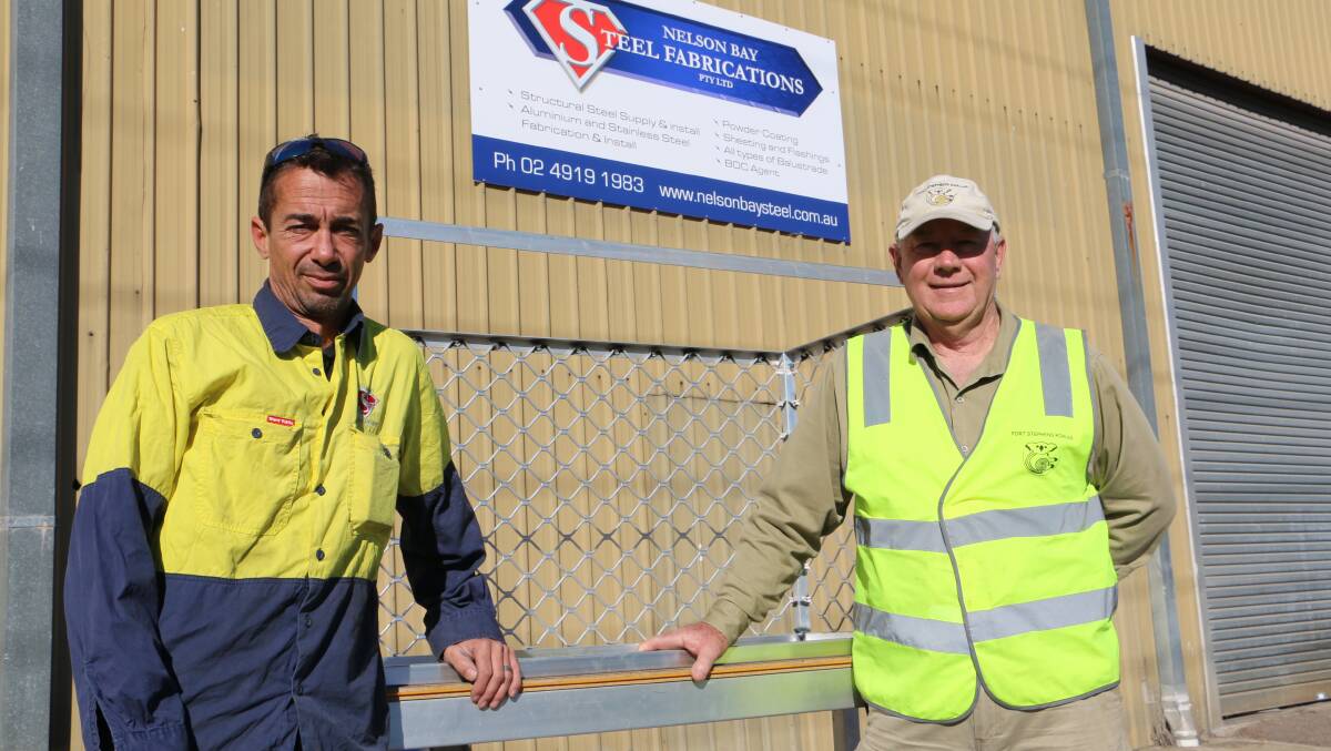 EASY ACCESS: Port Stephens Koalas secretary Ron Land (right) with Steve Gransden, from Nelson Bay Steel Fabrication, and the aluminium cage.