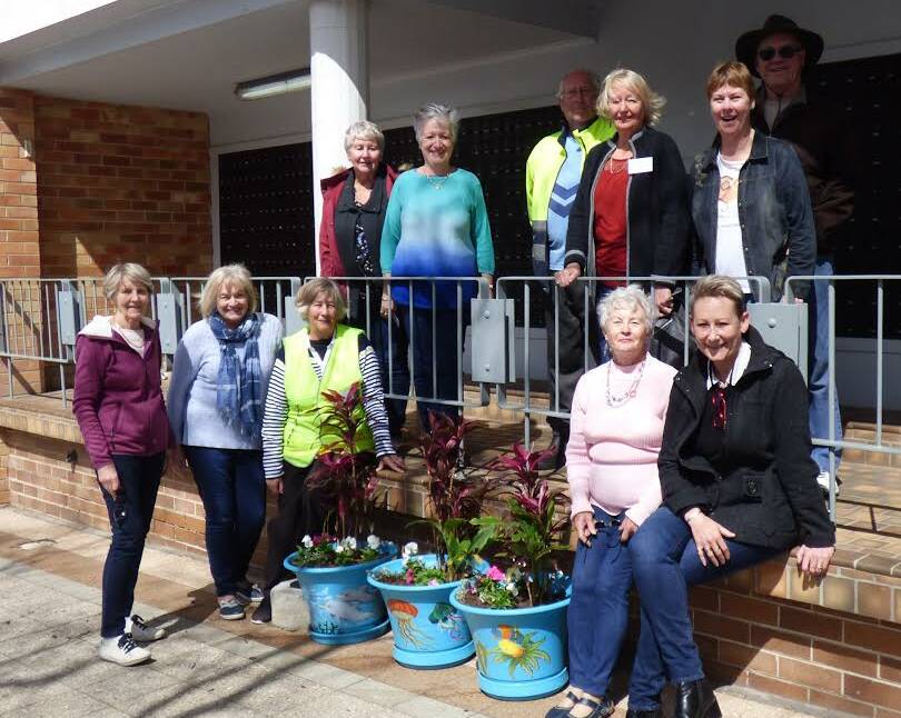PRIDE: Pictured are members of the Nelson Bay Civic Pride team and business chamber with the creative pots and plants outside the Post Office.