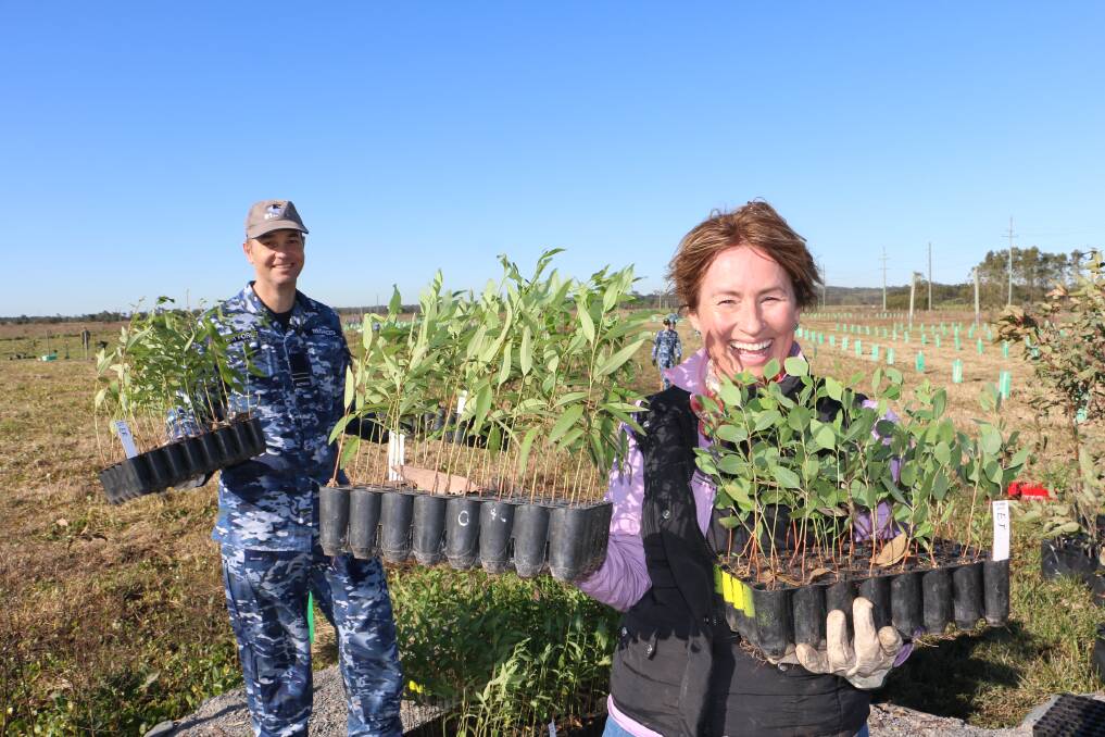 PLANTING: RAAF Williamtown's regional environmental officer Emily Ingram with FLLT Ewan Regazzo prepare to plant some of the koala feed trees at Williamtown.