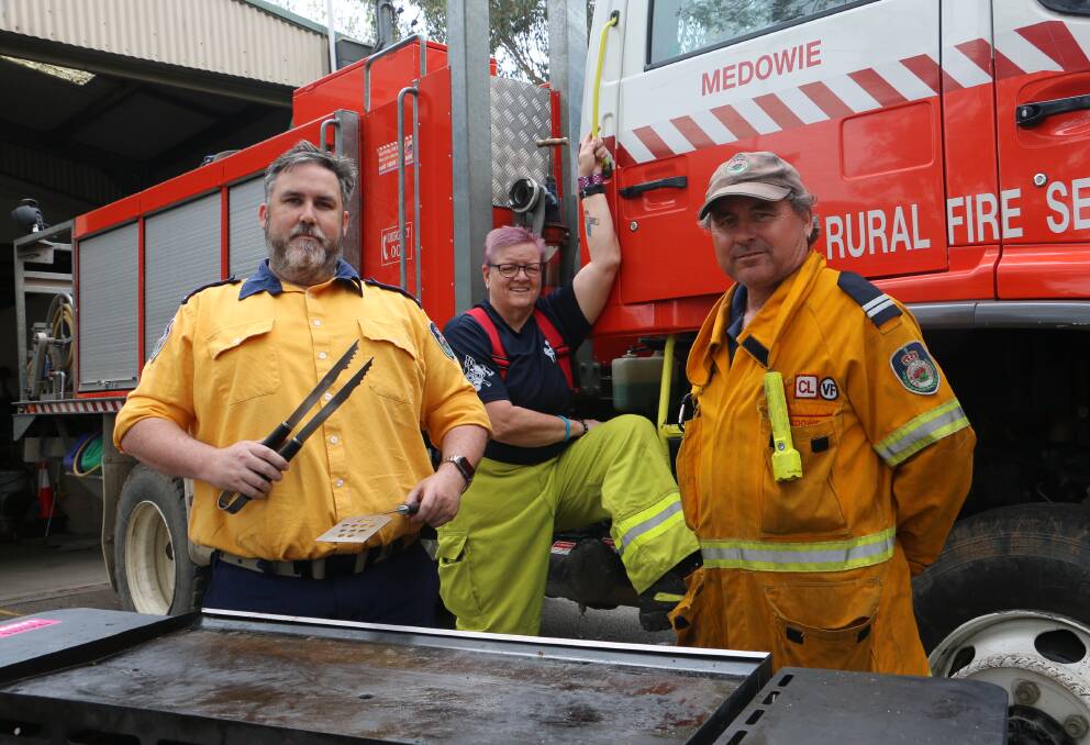 OPEN DAY: Medowie firefighters (from left) Gavin Smith, Louise McClelland and Peter Smith prepare for Saturday's 'Get Ready' day.