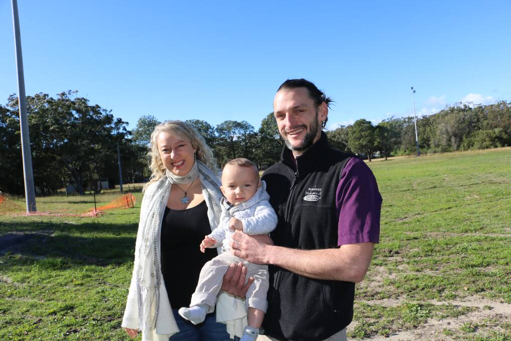 FUTURE PLANS: Lia and Ryan Pereira with baby Silas at the old Anna Bay Oval, where the couple are looking to move and expand Irukandji Shark and Ray Encounters. 