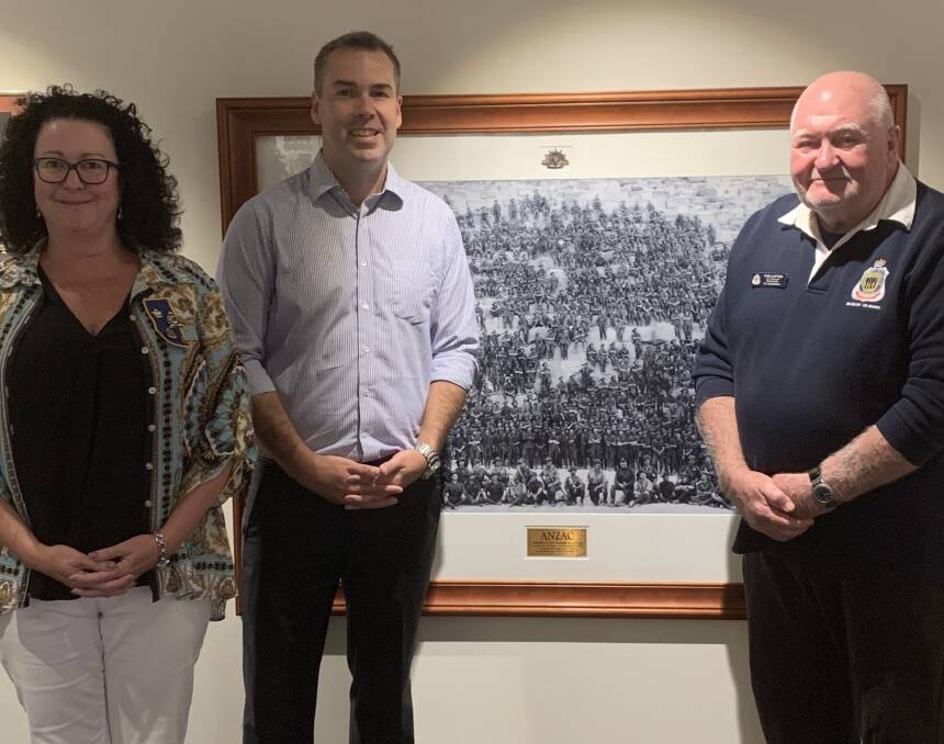ON DISPLAY: Pictured with the framed photo hanging at the Diggers club in Nelson Bay are Meagan Harding, Mayor Ryan Palmer and RSL Sub-Branch vice-president Tom Lupton. Picture: Supplied