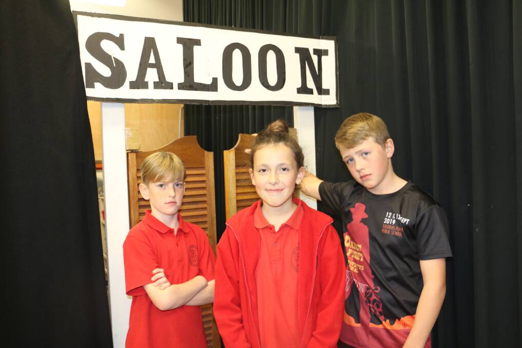 DANCE FIGHT: Stella Gilder, aged 10, plays Vera in Soldiers Point Public School's upcoming play. She is flanked left by Saddle-sore Sam played by 10-year-old Gus Adnam and right, Town Deputy Beau Hill, 12.