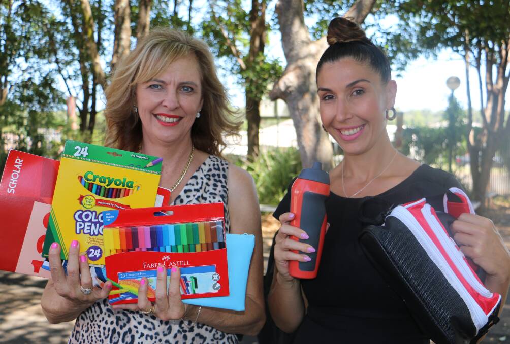 BACK TO SCHOOL: LJ Hooker's Tracy Jonovski and Melissa Parkinson with some of the stationery packed in the backpacks being distributed to schoolchildren in the local community.