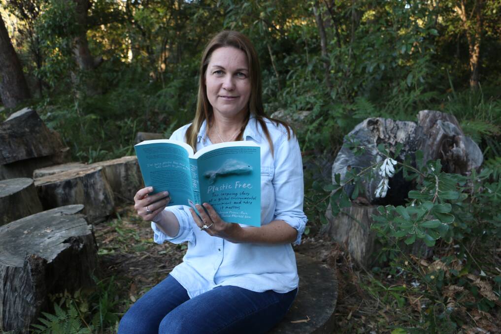 AUTHOR: Joanna Atherfold Finn with a copy of Plastic Free: The Inspiring Story of a Global Environmental Movement and Why It Matters which she co-wrote.