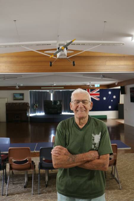 Wally Townsend with his model Piper J-3 Cub proudly displayed in the Harbourside Haven recreation hall at Shoal Bay.