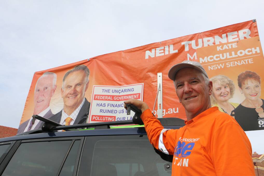 MINER: One Nation's Paterson candidate Neil Turner with his placard-laden vehicle in Raymond Terrace.