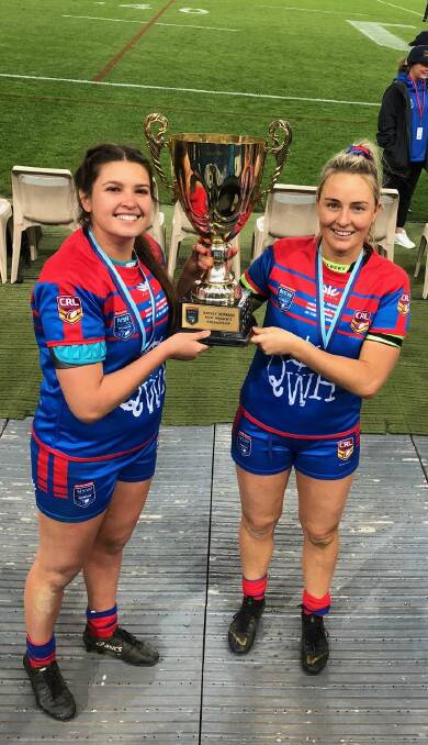 CUP WINNERS: Bobbi Law (left), from Nelson Bay, and Olivia Higgins, from Raymond Terrace, are all smiles as they lift the NSW trophy. Picture: Kathy Higgins
