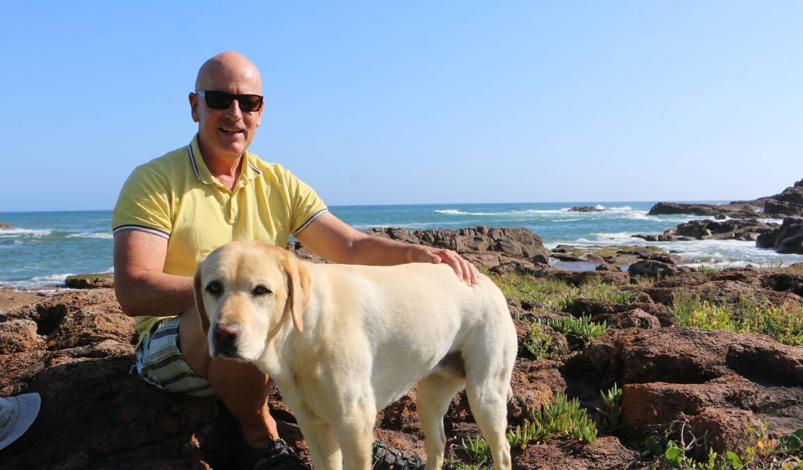 DOG OWNER: Anna Bay's Andrew Searles with his labrador Elsa near the access to Anna Bay's dog walking beach.