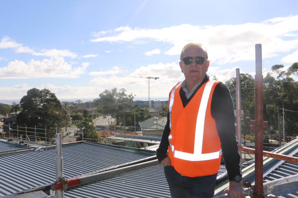 MYSTERY SOLVED: Developer Rod Salmon atop his Talmora development with the Ascent site crane in the background.