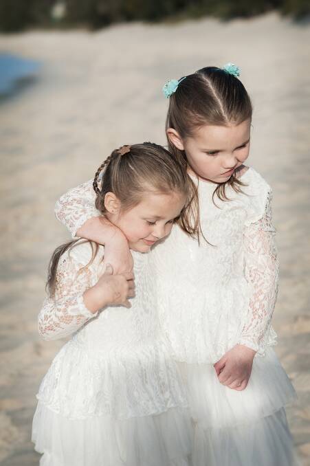 COMMUNITY SUPPORT: Seven-year-old Bella Howard, from Shoal Bay, with her younger sister, Mia. Picture: Rachel Nicetin
