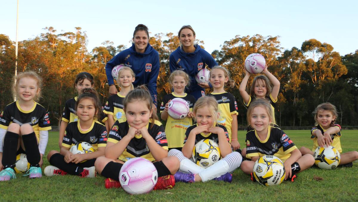 ROLE MODELS: Jets W-League players Paige Kingston-Hogg and Sophie Nenadovic with some of the girls from the Nelson Bay football club's under 6 team.