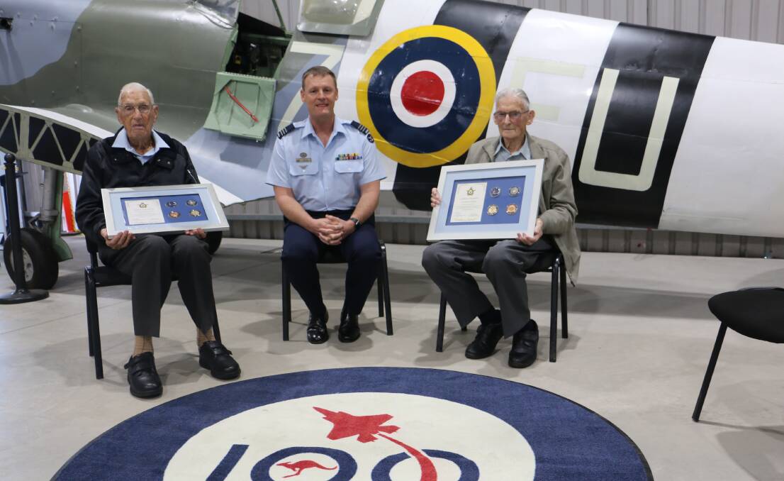 PRESENTATION: Bill Cox (left) and Eric Hill are presented with their framed mementos by Air Base Executive Officer/Commanding Officer 26SQN - Wing Commander Matthew Walsh last Friday at Williamtown's Fighter World museum.