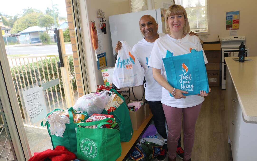 FOOD DONATIONS: Pastor Kesh Goran and wife Catherine with some of the food items donated when Hope Cottage was established last year at All Saints Anglican Church.