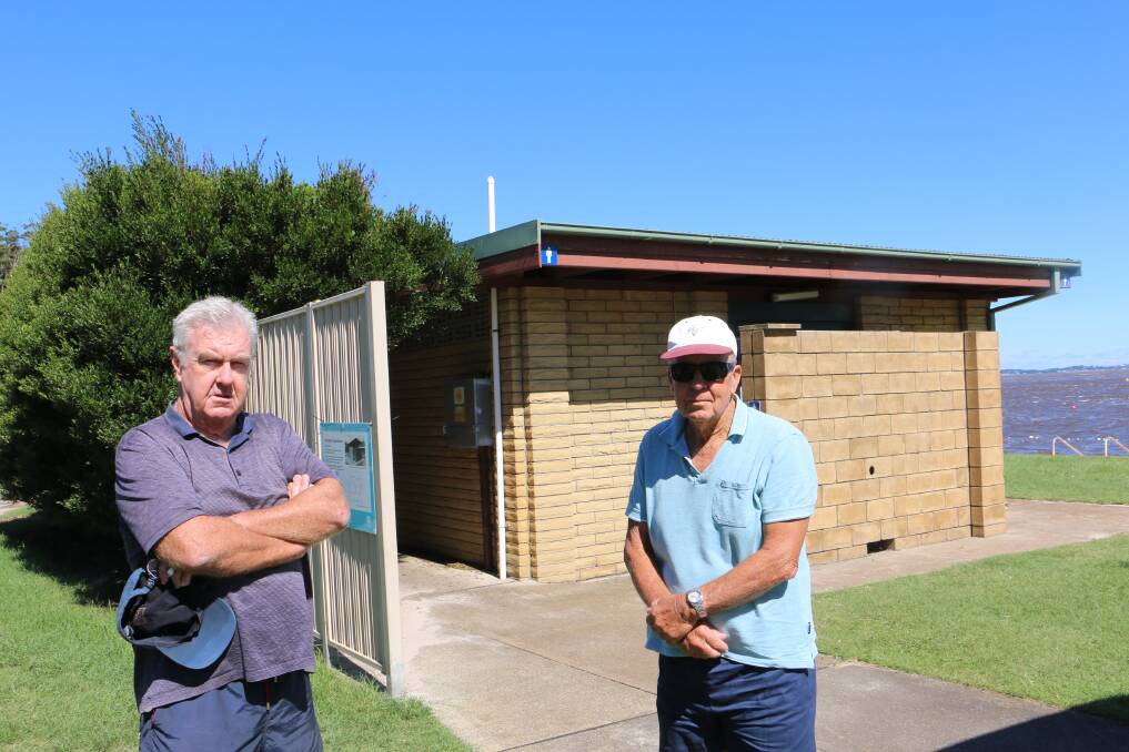 ANGRY: Shoal Bay residents and regular users of Little Beach Chris Bastic (left) and John Jarvis outside the amenities building and garden.