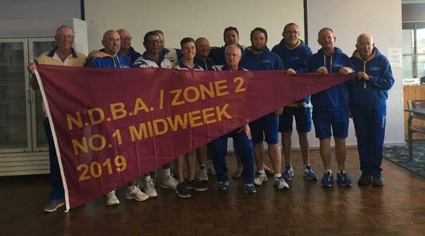 WINNERS: The Soldiers Point Bowling Club's winning midweek pennant team with the flag. Starting this weekend, there will be plenty of bowls at the club. Picture: Supplied